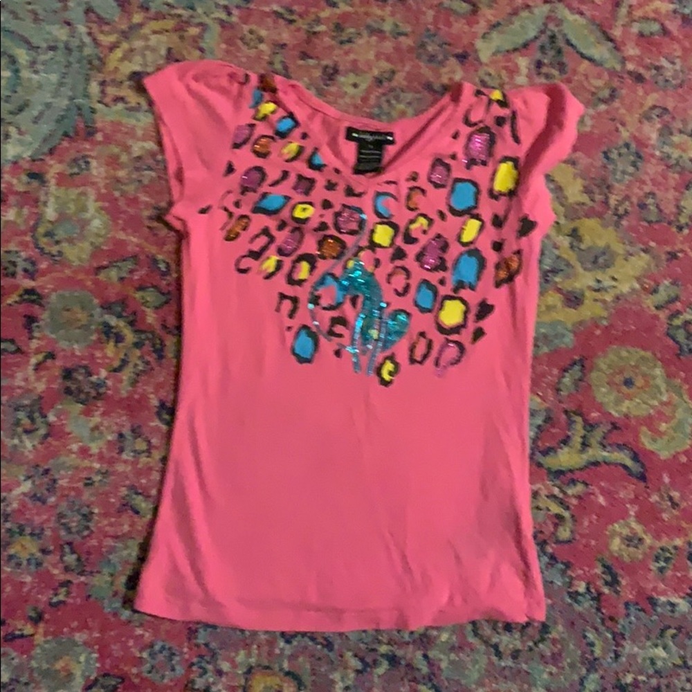 It is a hot pink shirt with rainbow leopard print